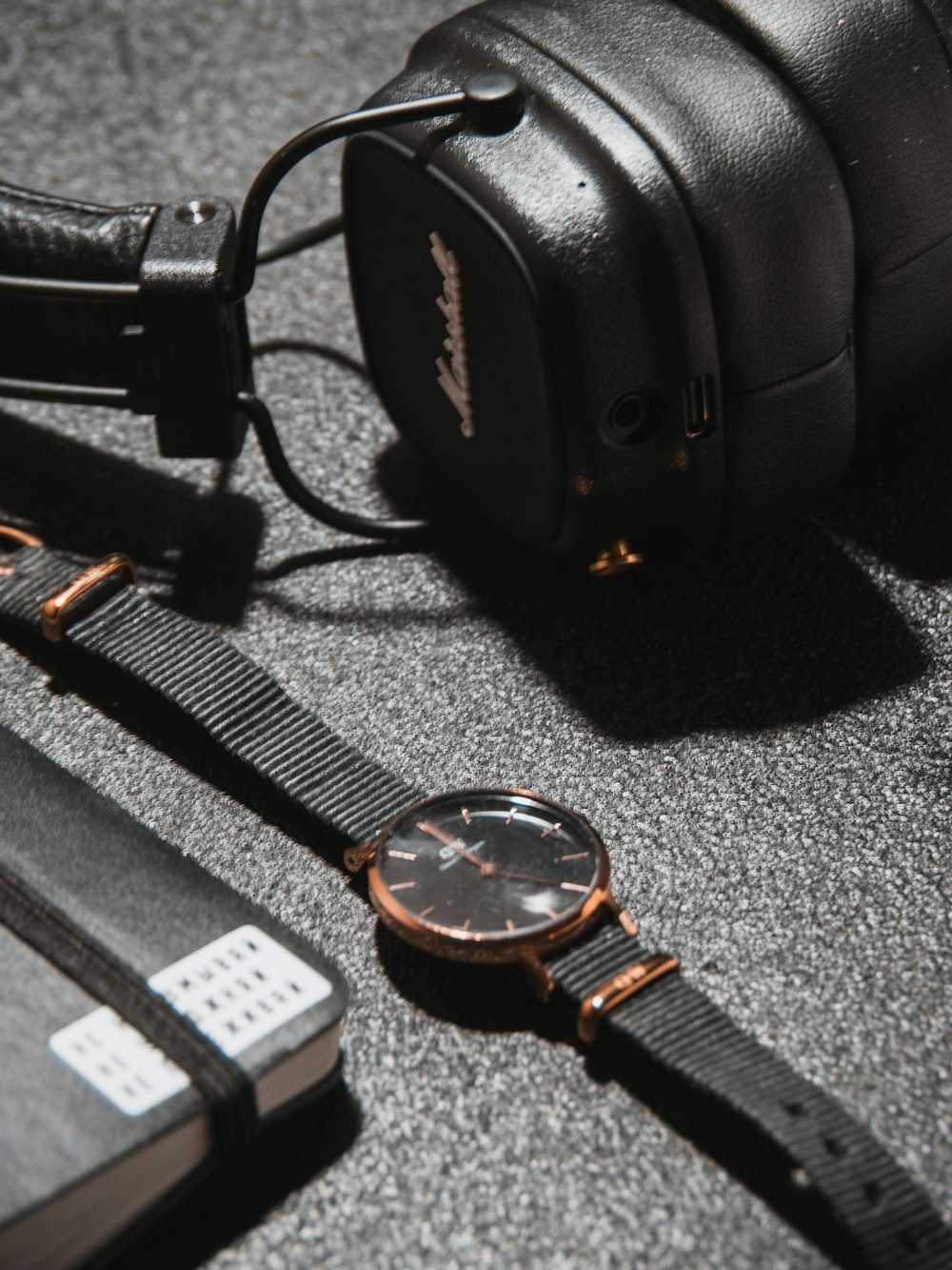 a pair of headphones and a watch on a table