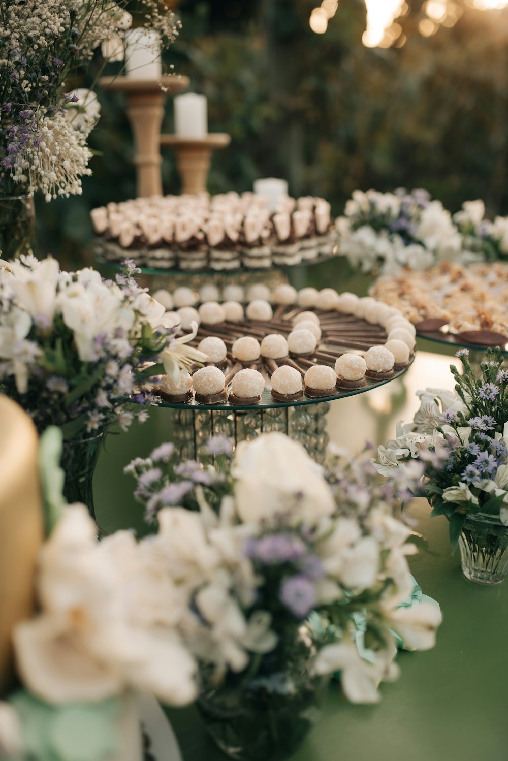 a table topped with lots of cakes and cupcakes