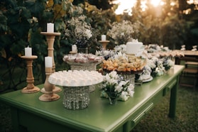 a green table topped with lots of food