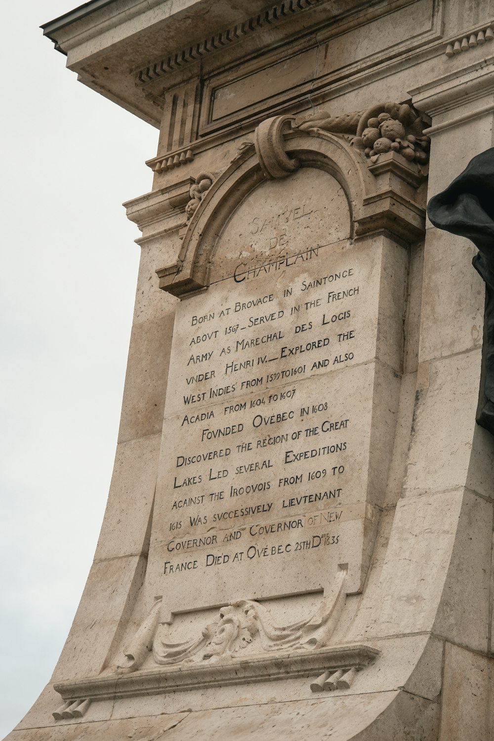 a monument with a statue of a man on top of it