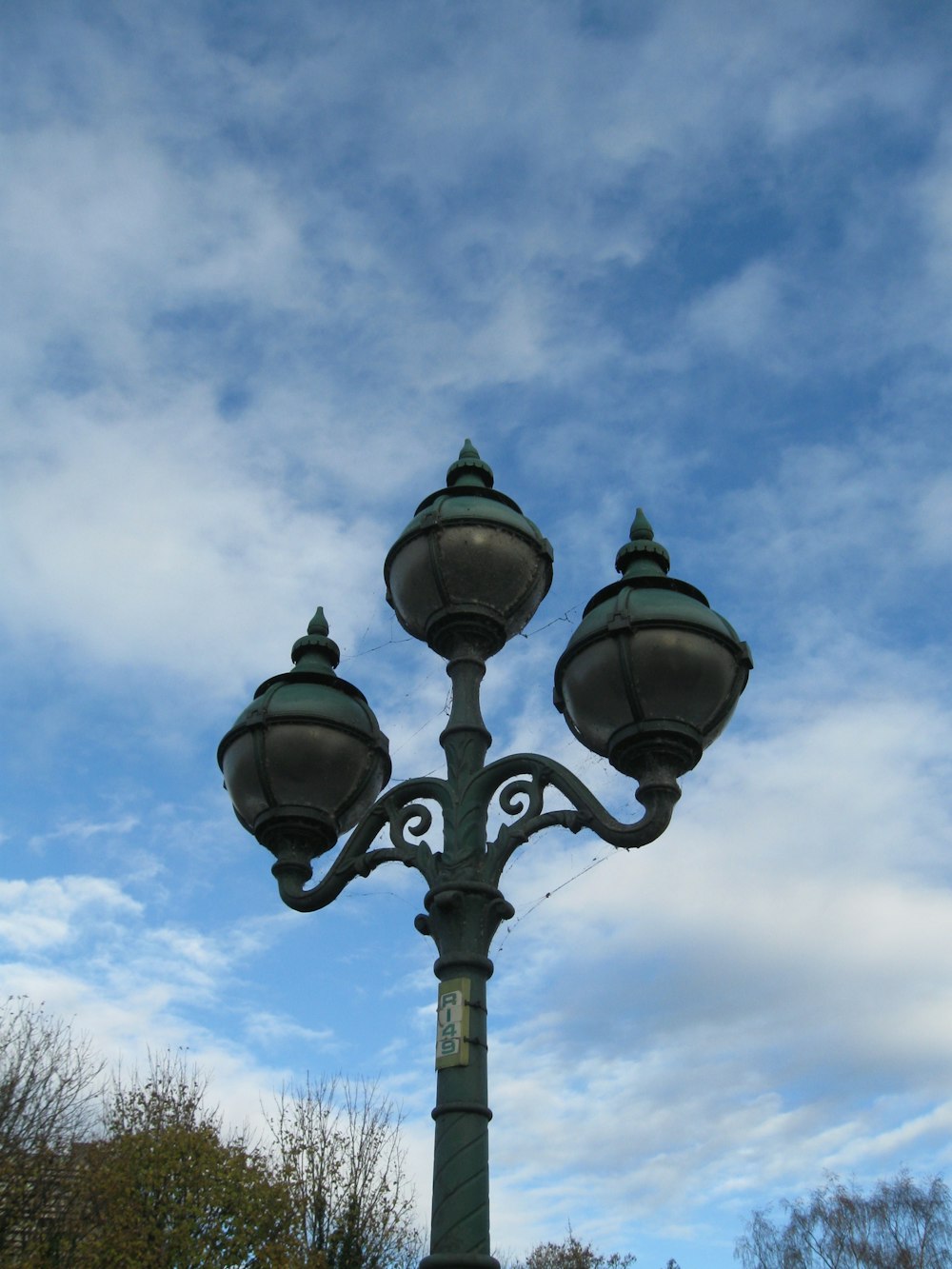 a street light with a blue sky in the background