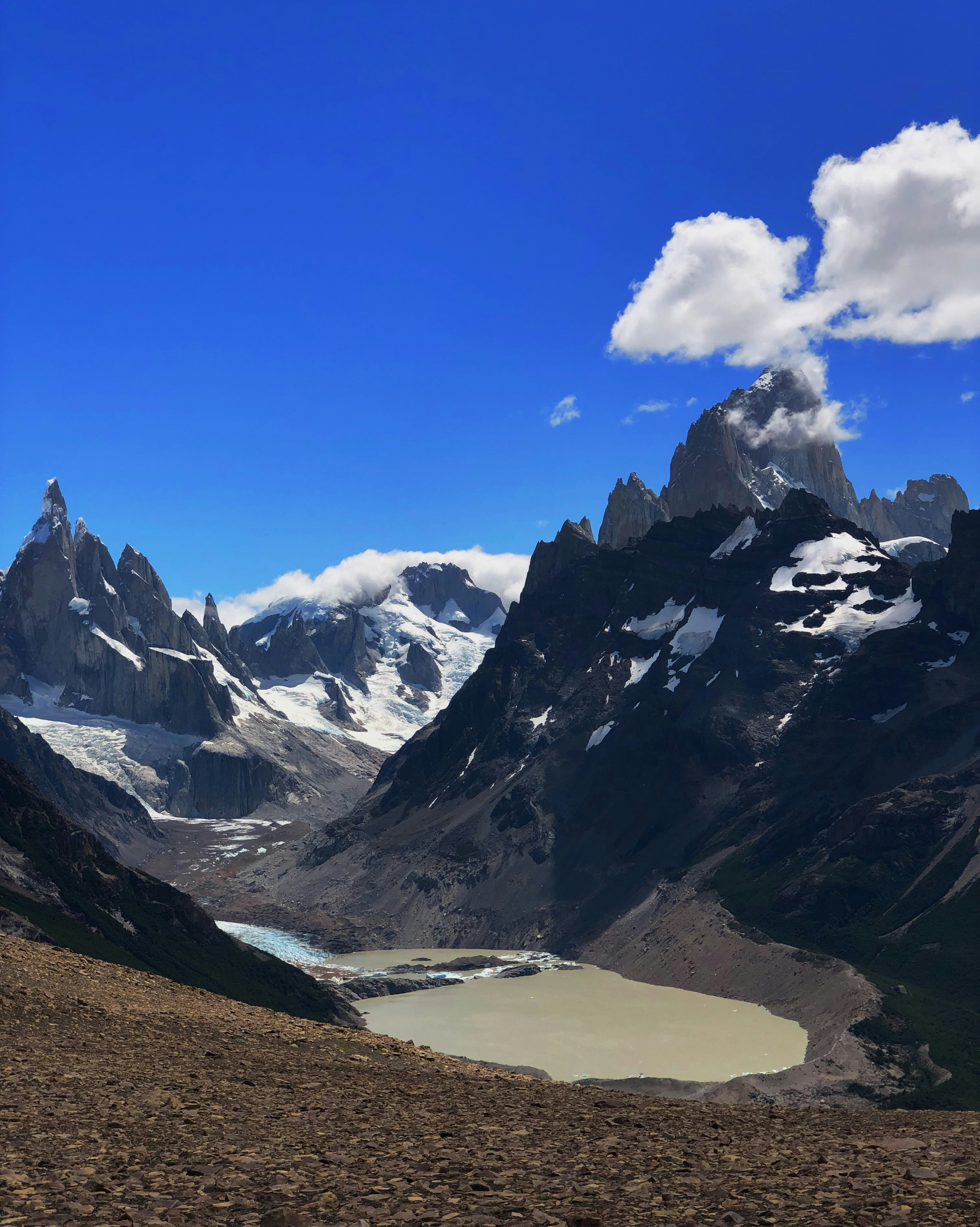 a mountain range with a lake in the foreground