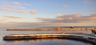a large body of water next to a pier