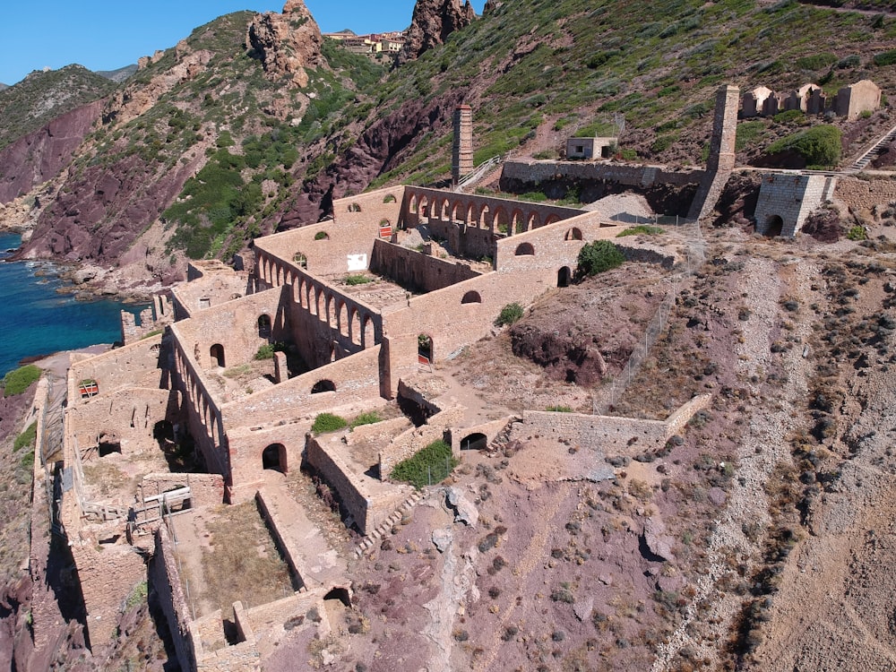 an aerial view of a building on the side of a mountain