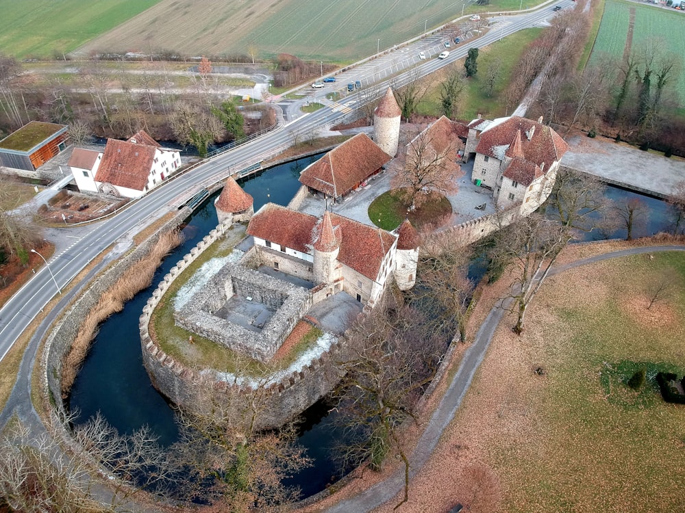 an aerial view of a castle with a river running through it