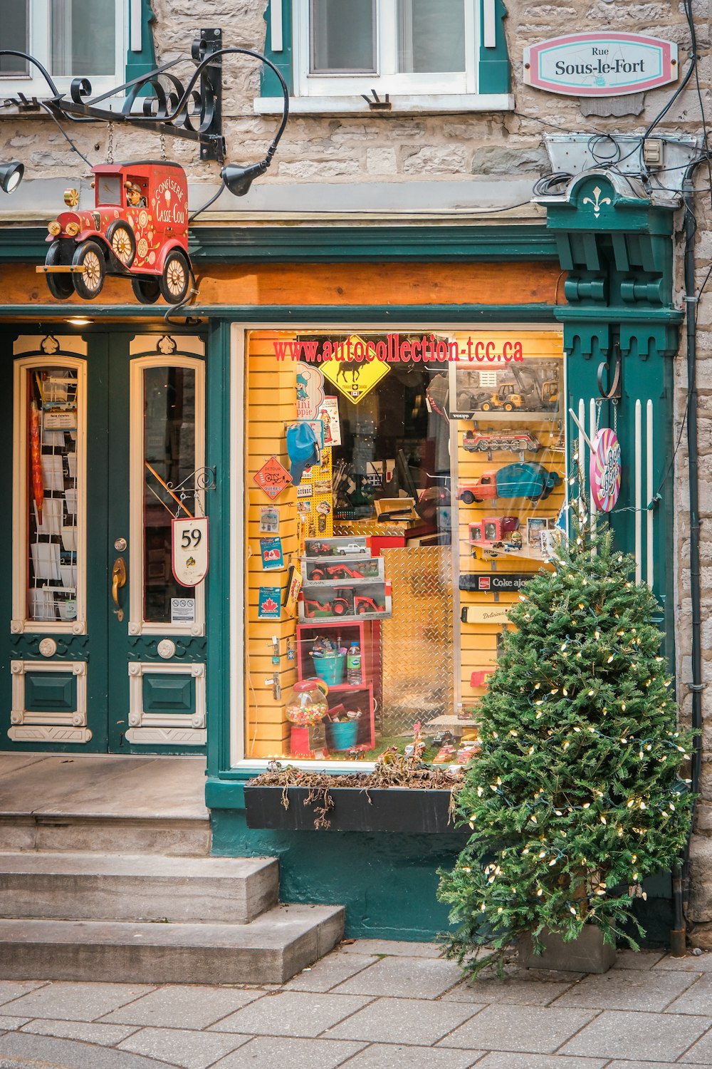 a store front with a tree in front of it