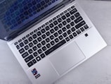 an open laptop computer sitting on top of a table