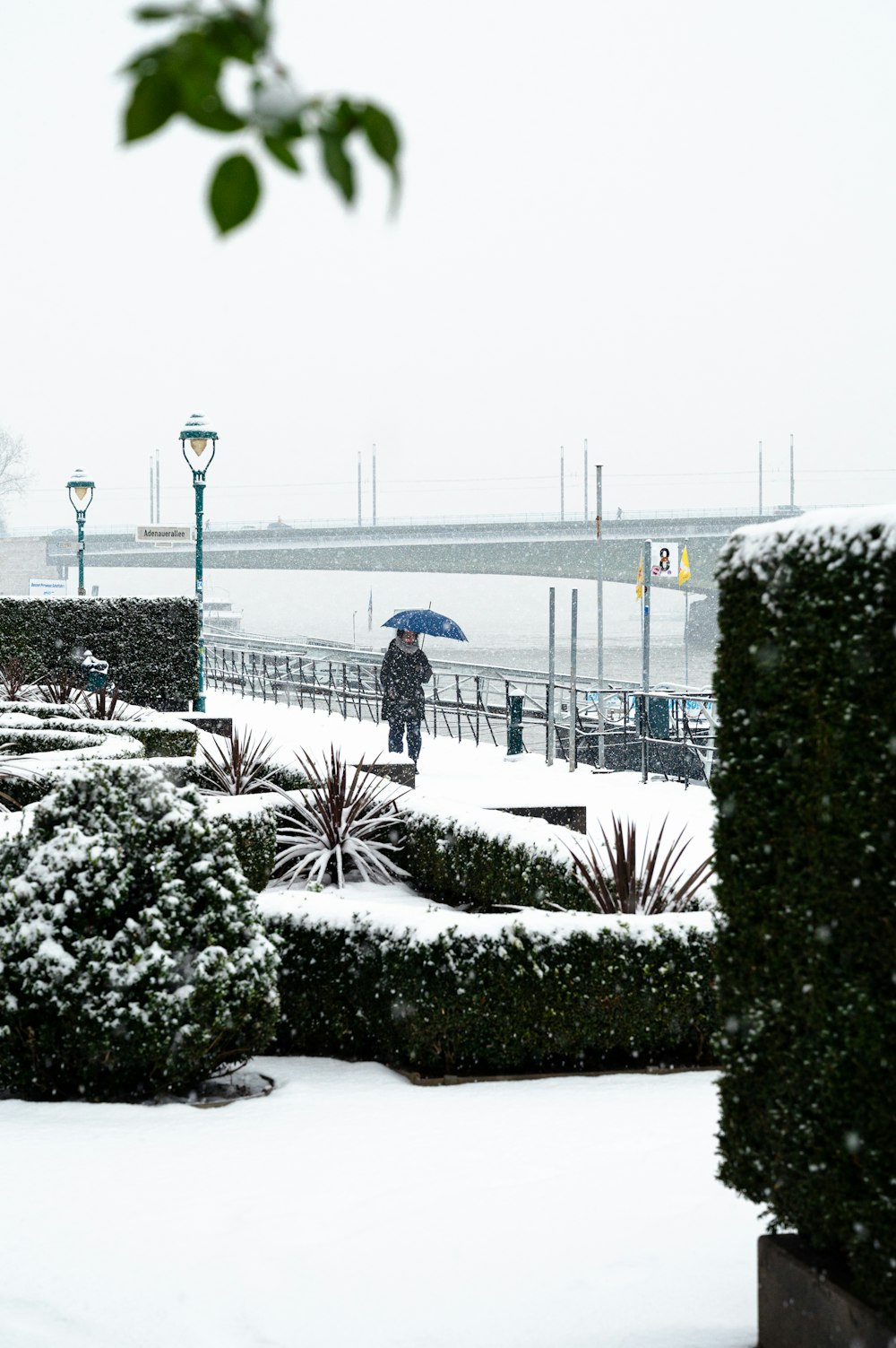 a person walking in the snow with an umbrella