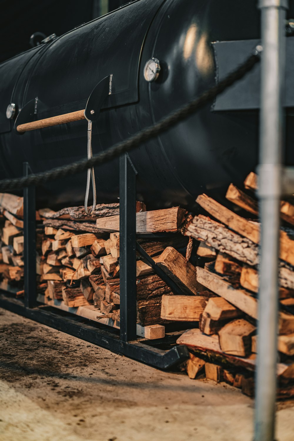 a train is parked next to a pile of logs