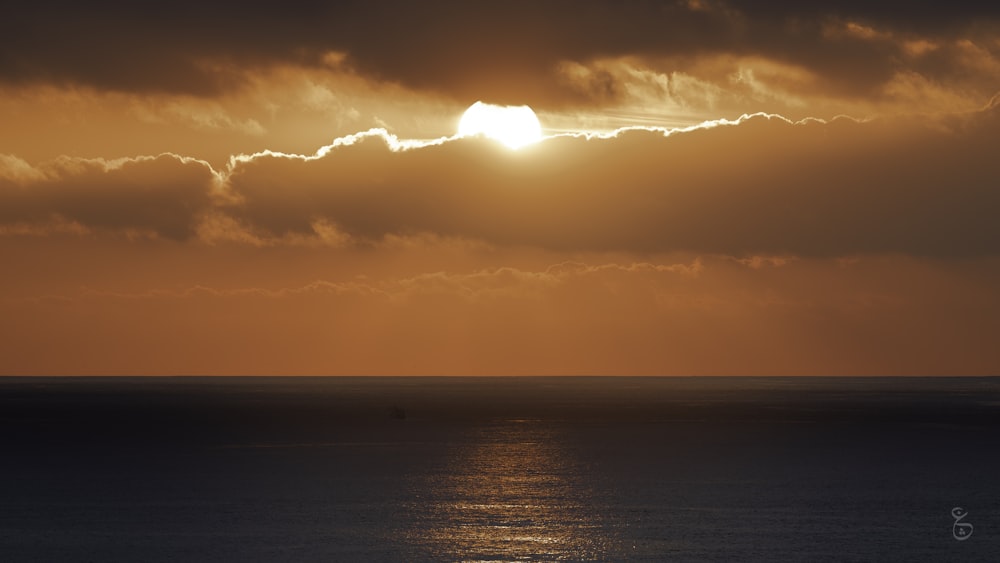 a large body of water under a cloudy sky