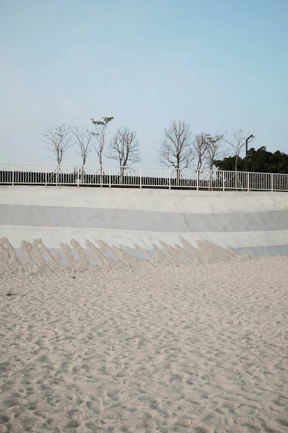 a man riding a skateboard on top of a sandy beach