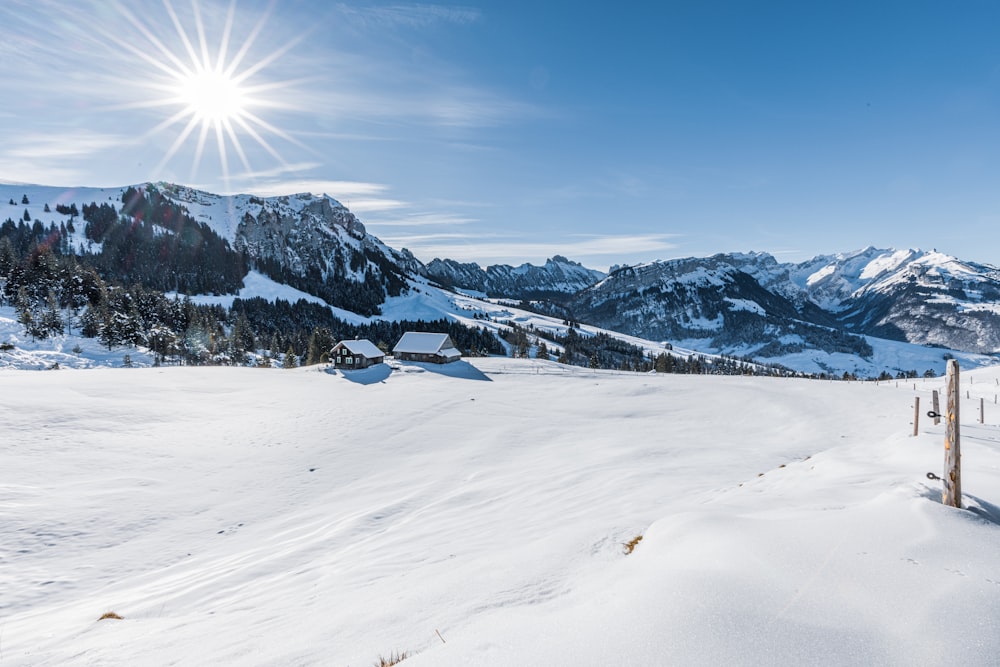 the sun shines brightly over a snowy mountain range