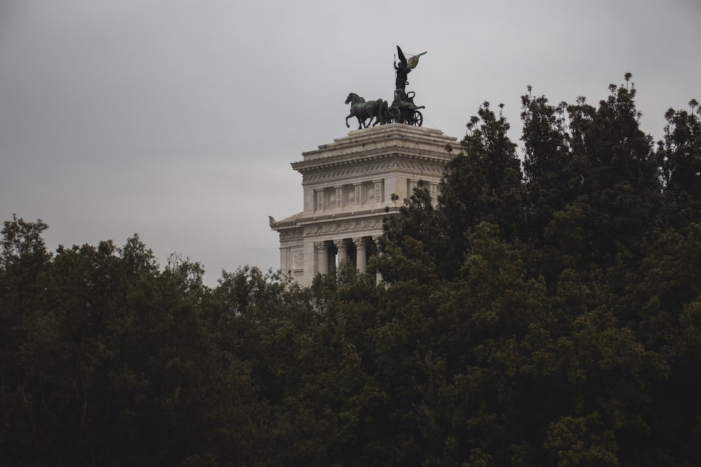 a statue of a man on a horse on top of a building