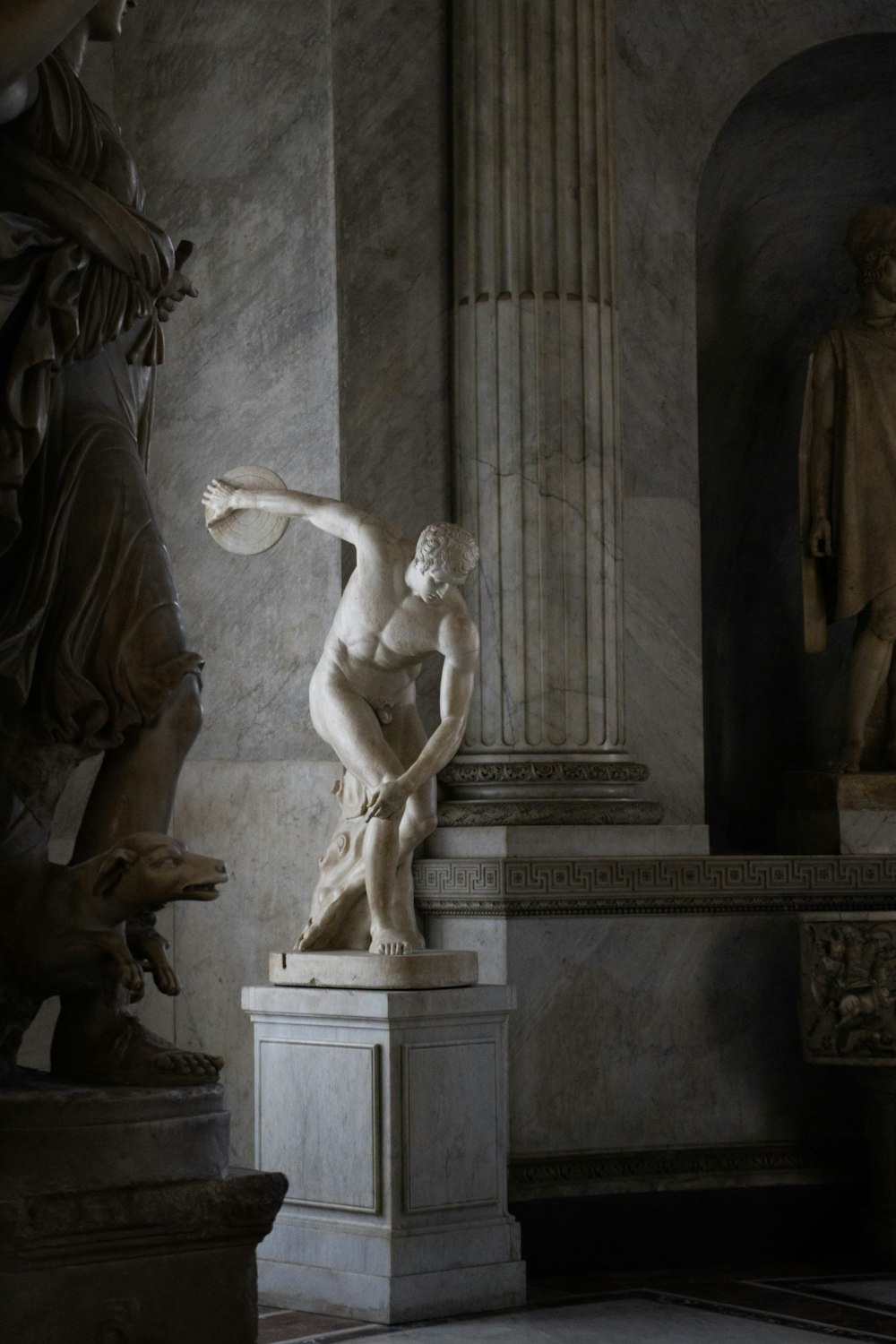 a statue of a woman sitting on a pedestal