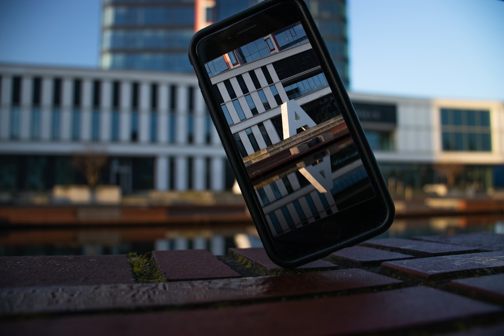 a cell phone sitting on top of a wooden table