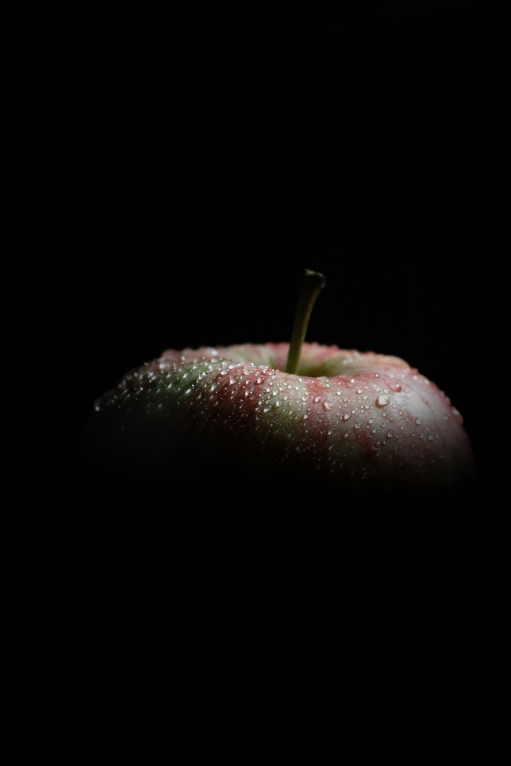 an apple with drops of water on it