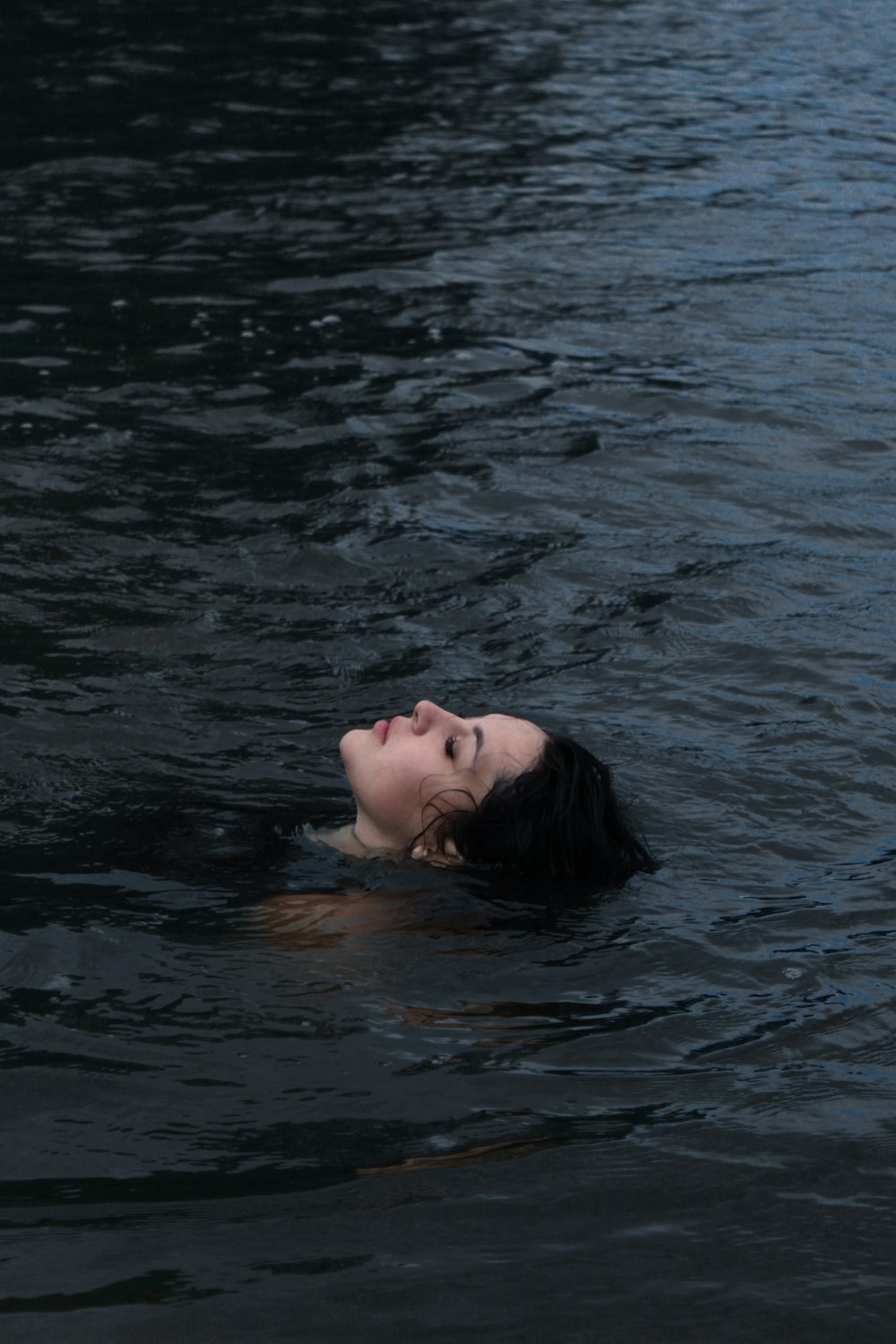 a woman floating in a body of water