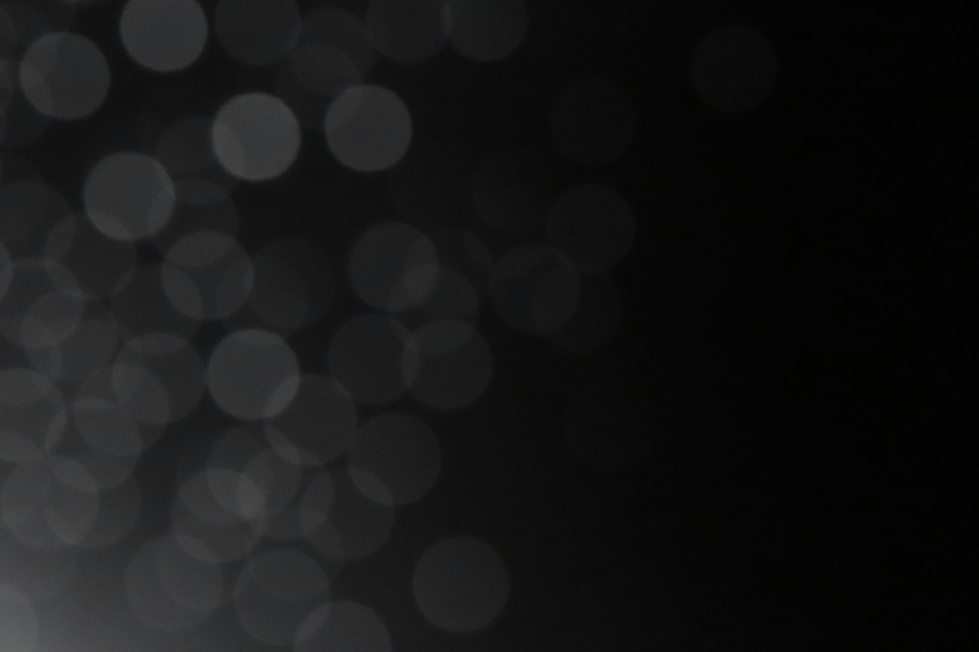 a black and white photo of a light in the dark