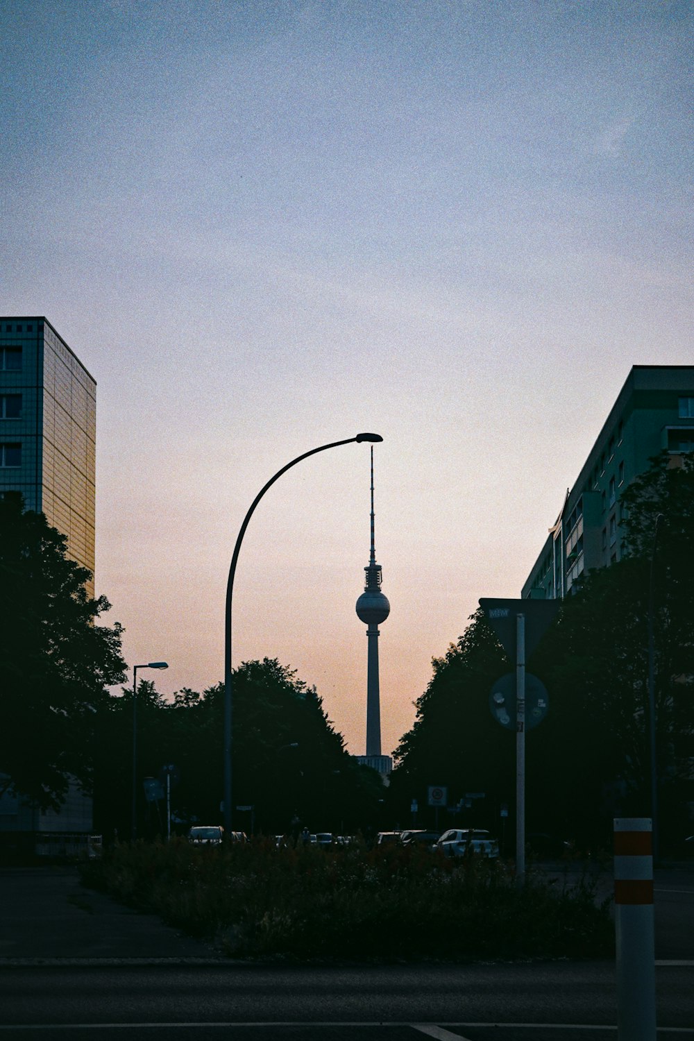a street light with a tall tower in the background