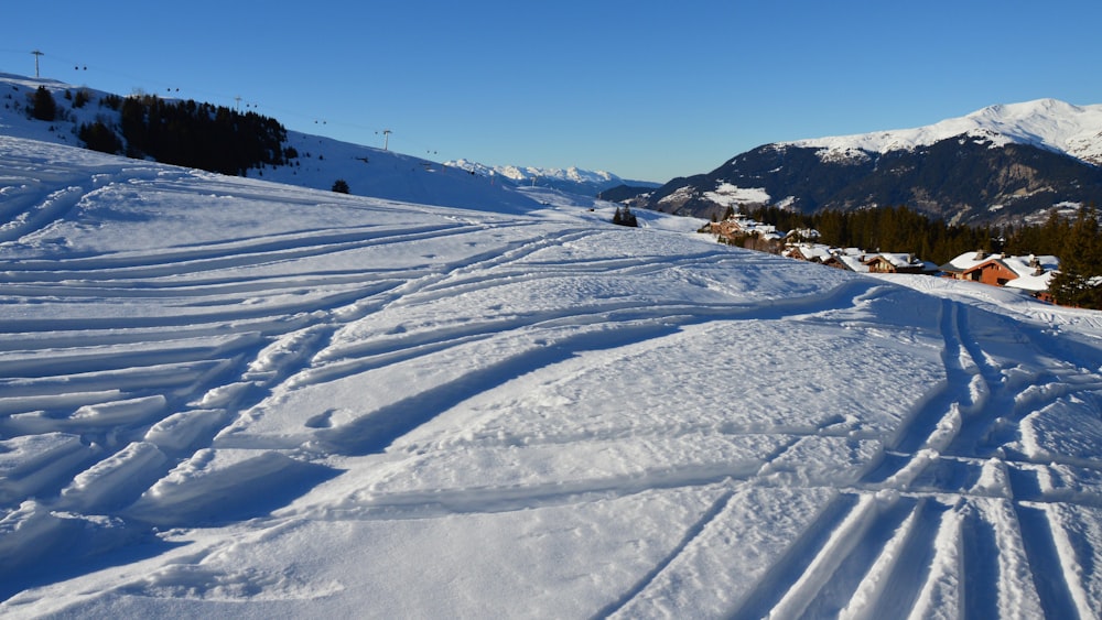 a ski slope with tracks in the snow