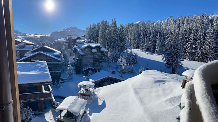 Snow-covered chalet rooftops in Courchevel
