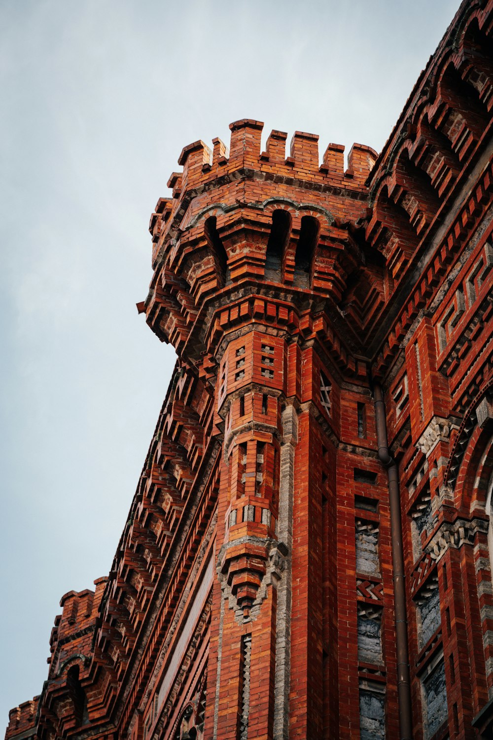 a very tall brick building with a clock on it's side