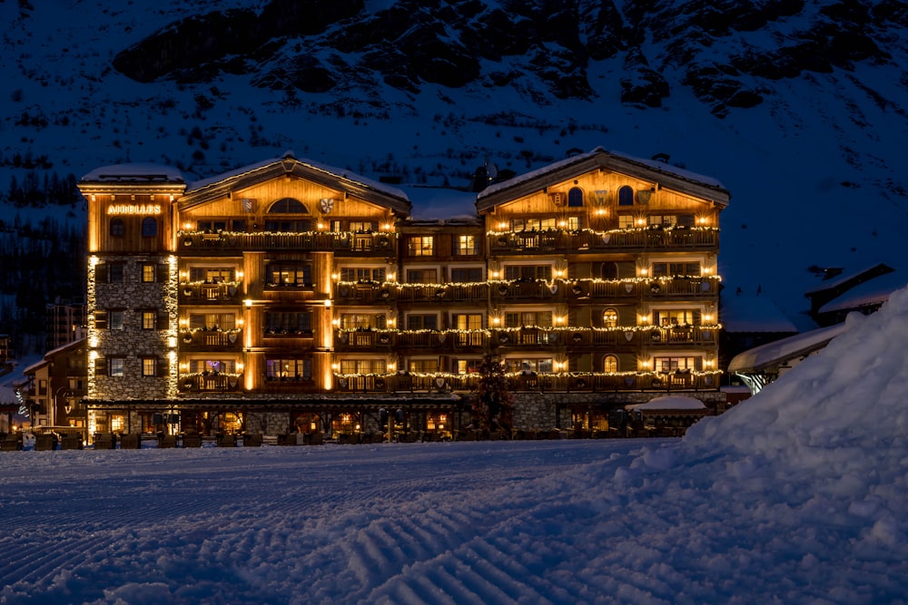 a hotel lit up at night in the snow