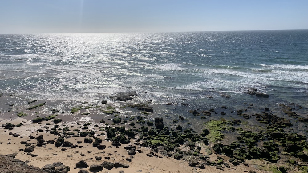 a view of the ocean from a rocky shore