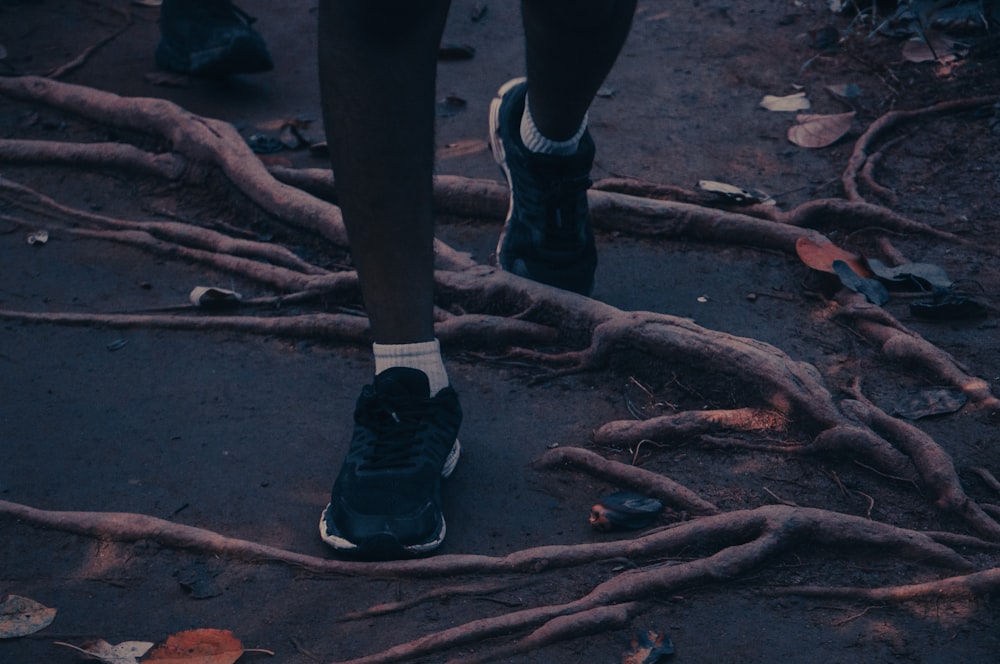 a person standing in front of a bunch of branches