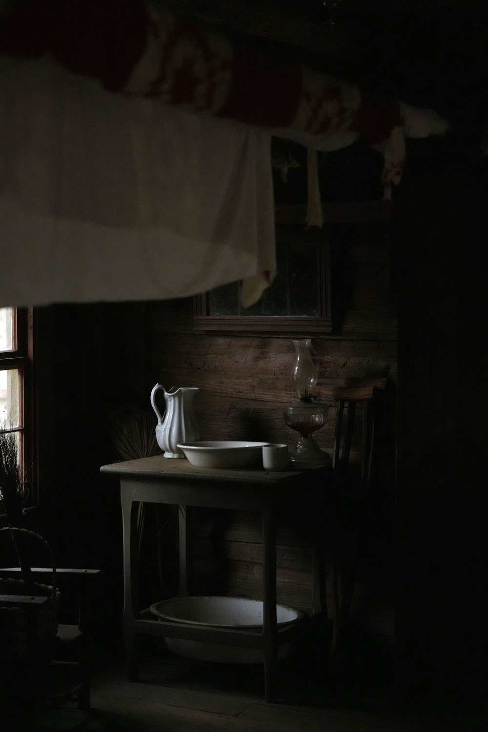 a dark room with a table and a window