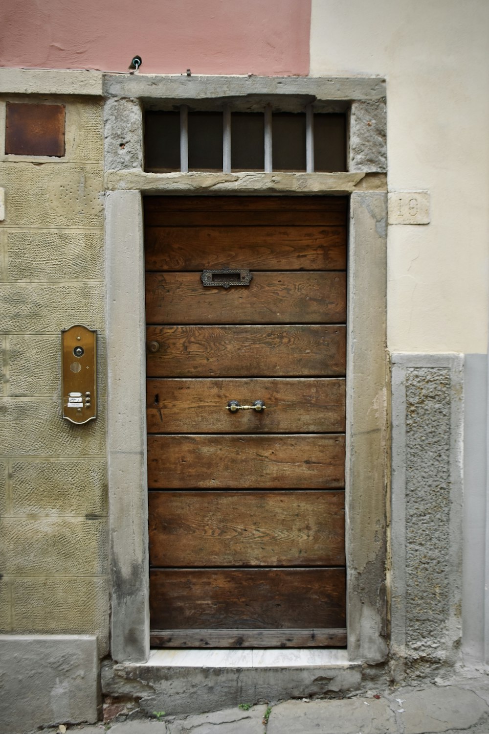 a large wooden door with a window above it