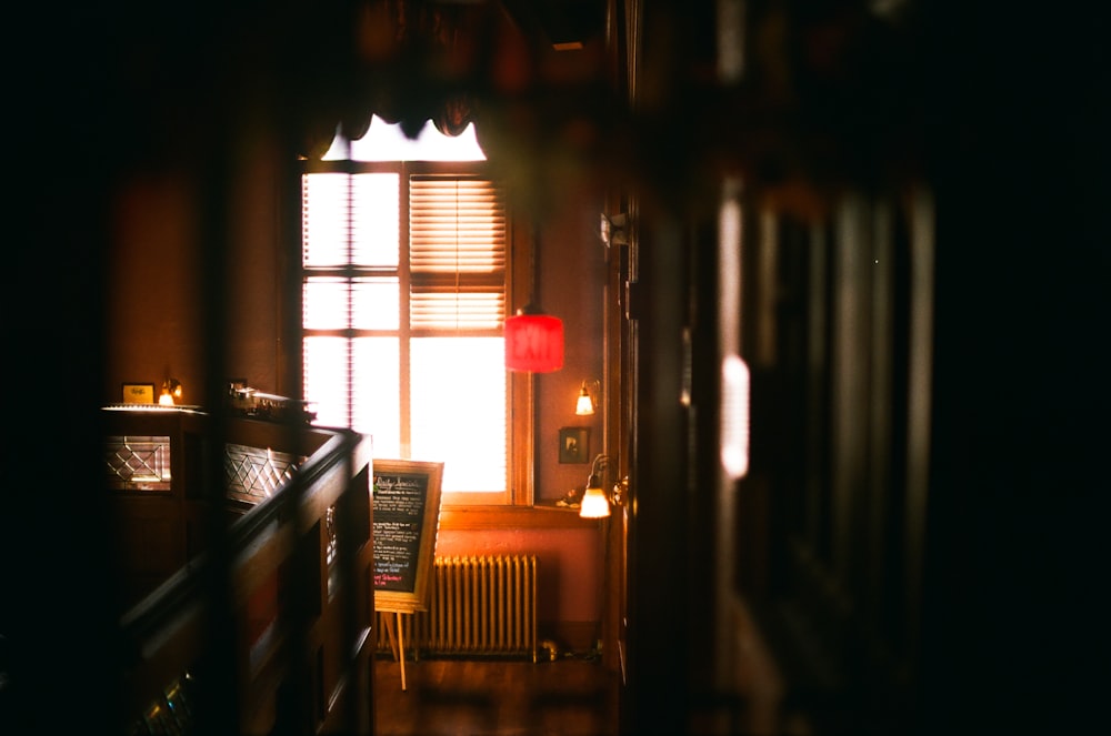 a dimly lit room with a chair and a lamp