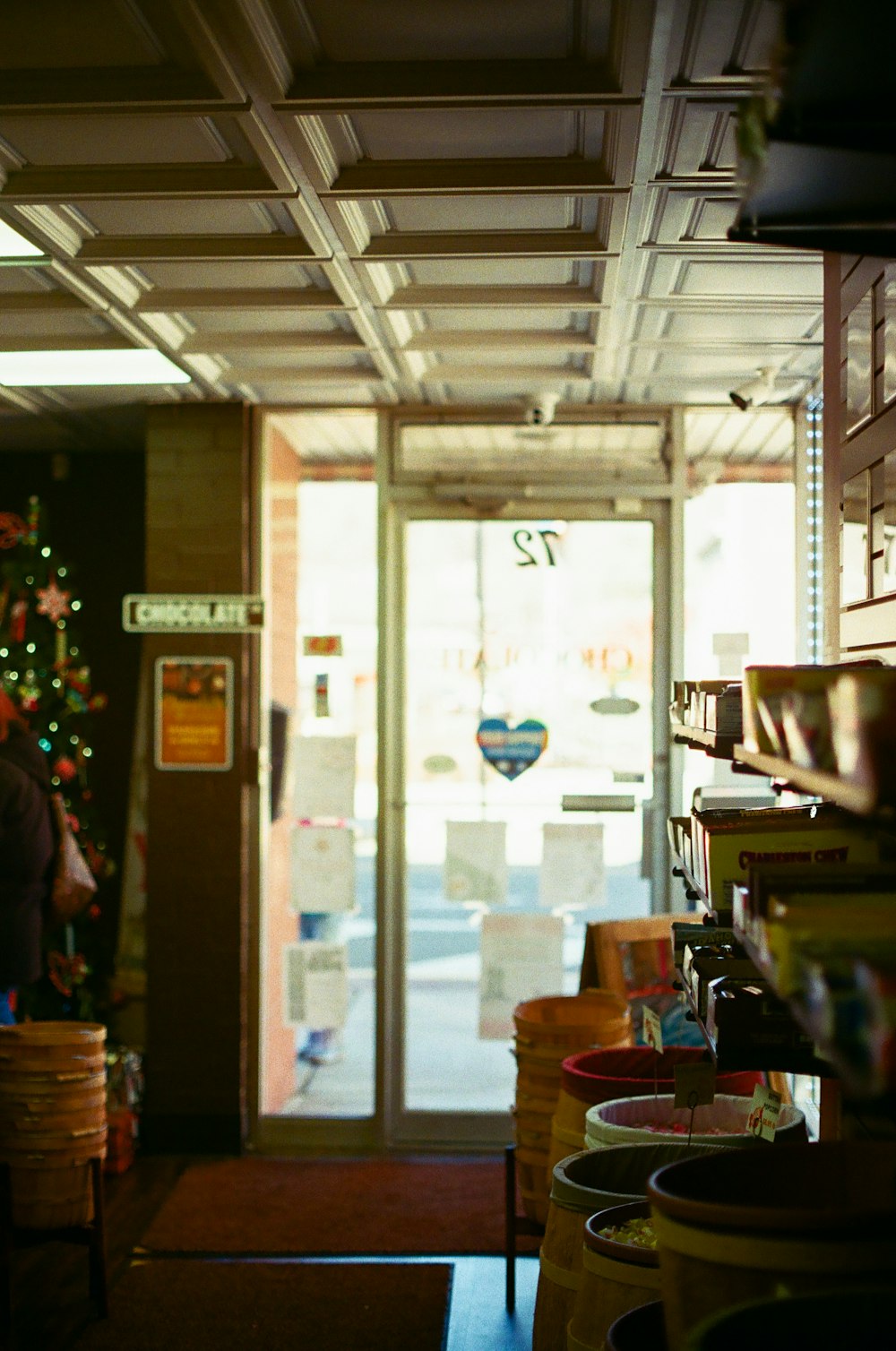 a store with a christmas tree in the window