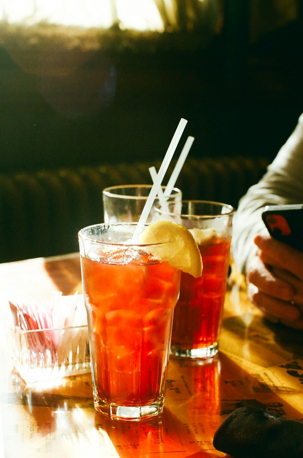 a couple of glasses filled with drinks on top of a table