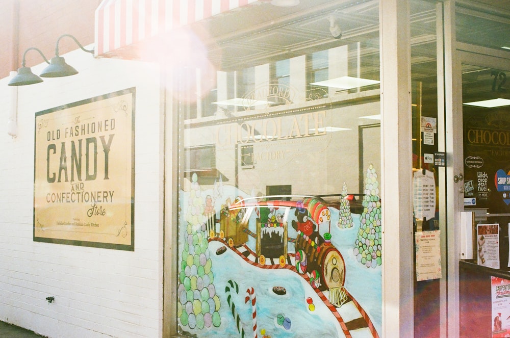 a store front with a painted mural of a carnival ride