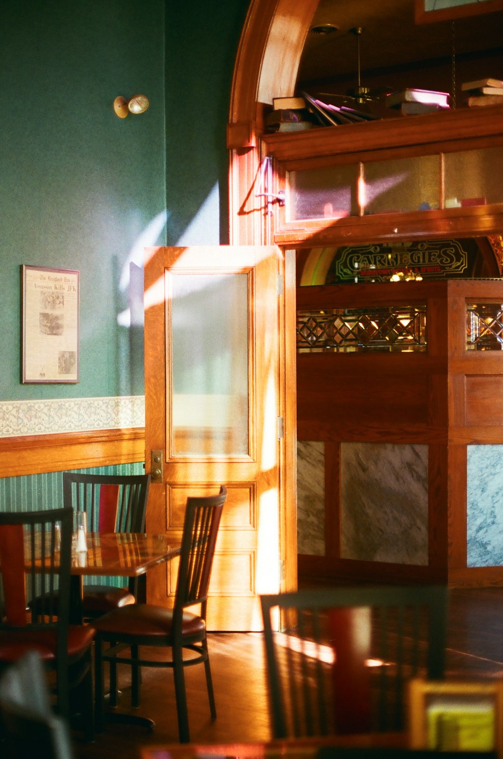 a dining room with a wooden table and chairs