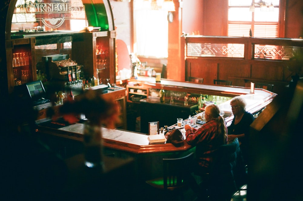 a group of people sitting at a bar