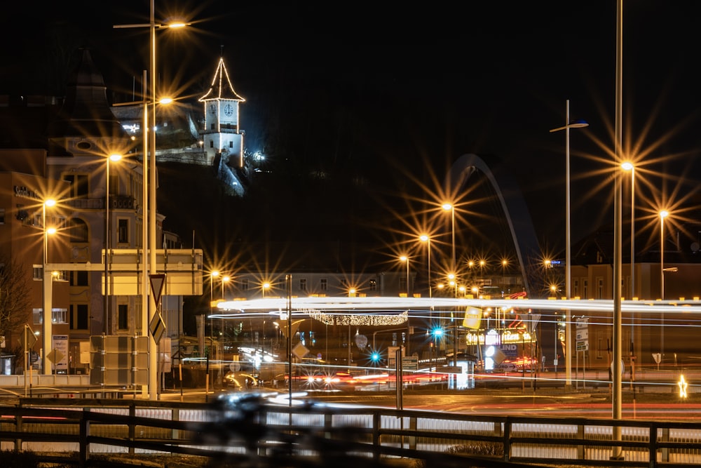 a city at night with street lights and a bridge