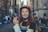 a woman with red hair wearing a helmet