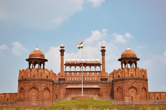 a large brick building with a flag on top of it