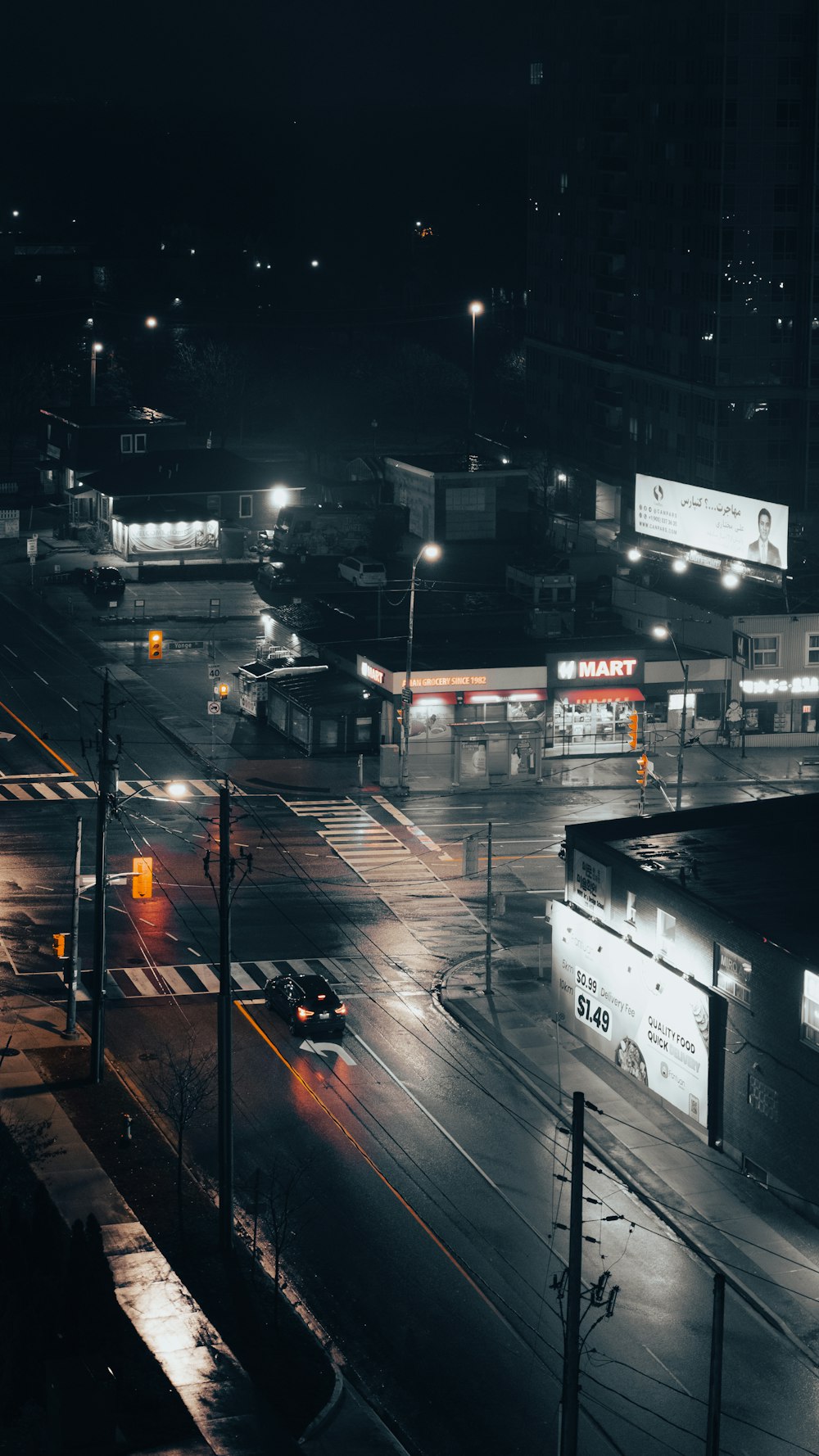 a city street at night with traffic lights