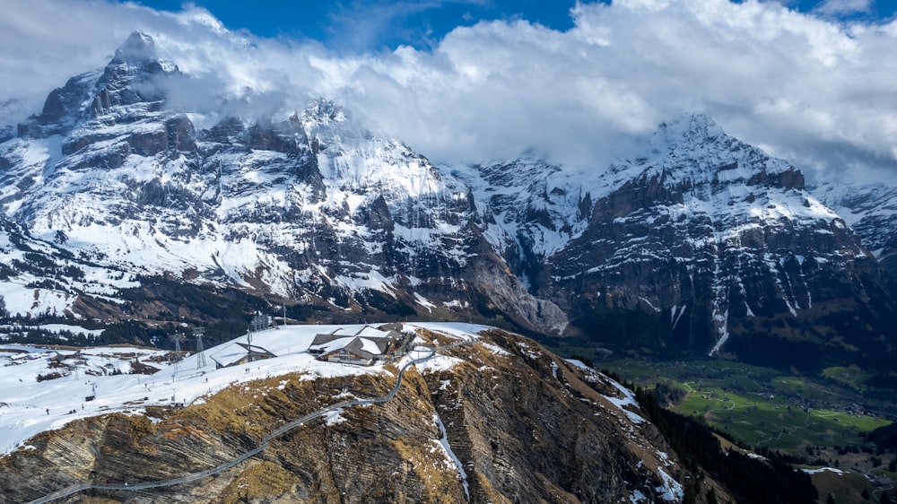 a snow covered mountain with a road running through it