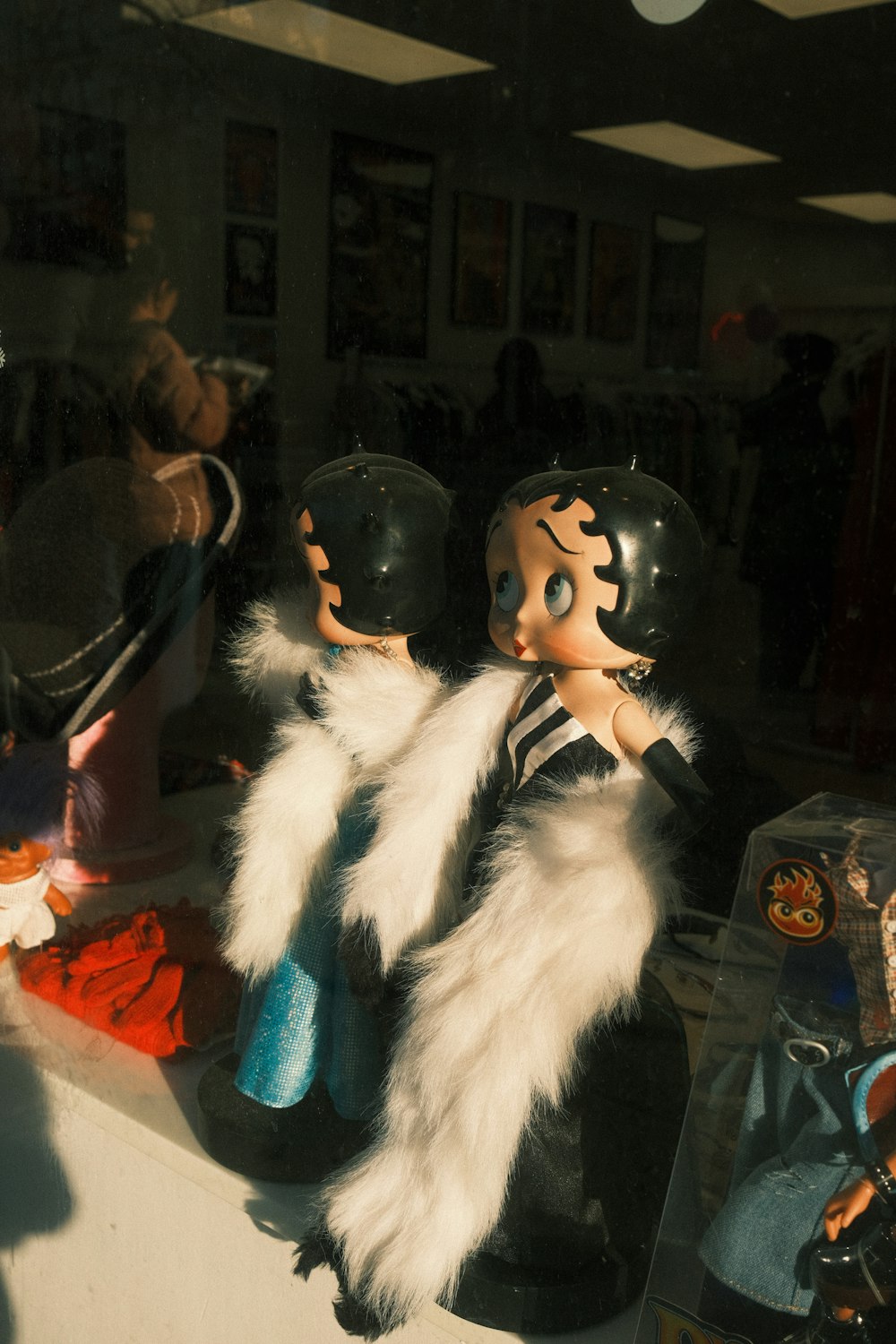 a couple of dolls sitting on top of a counter