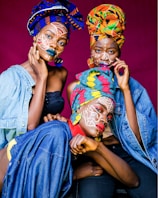 two women with painted faces sitting next to each other