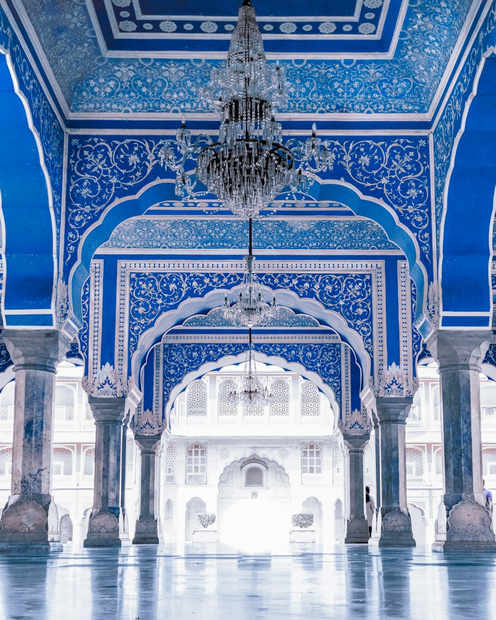 a blue and white building with a chandelier hanging from the ceiling