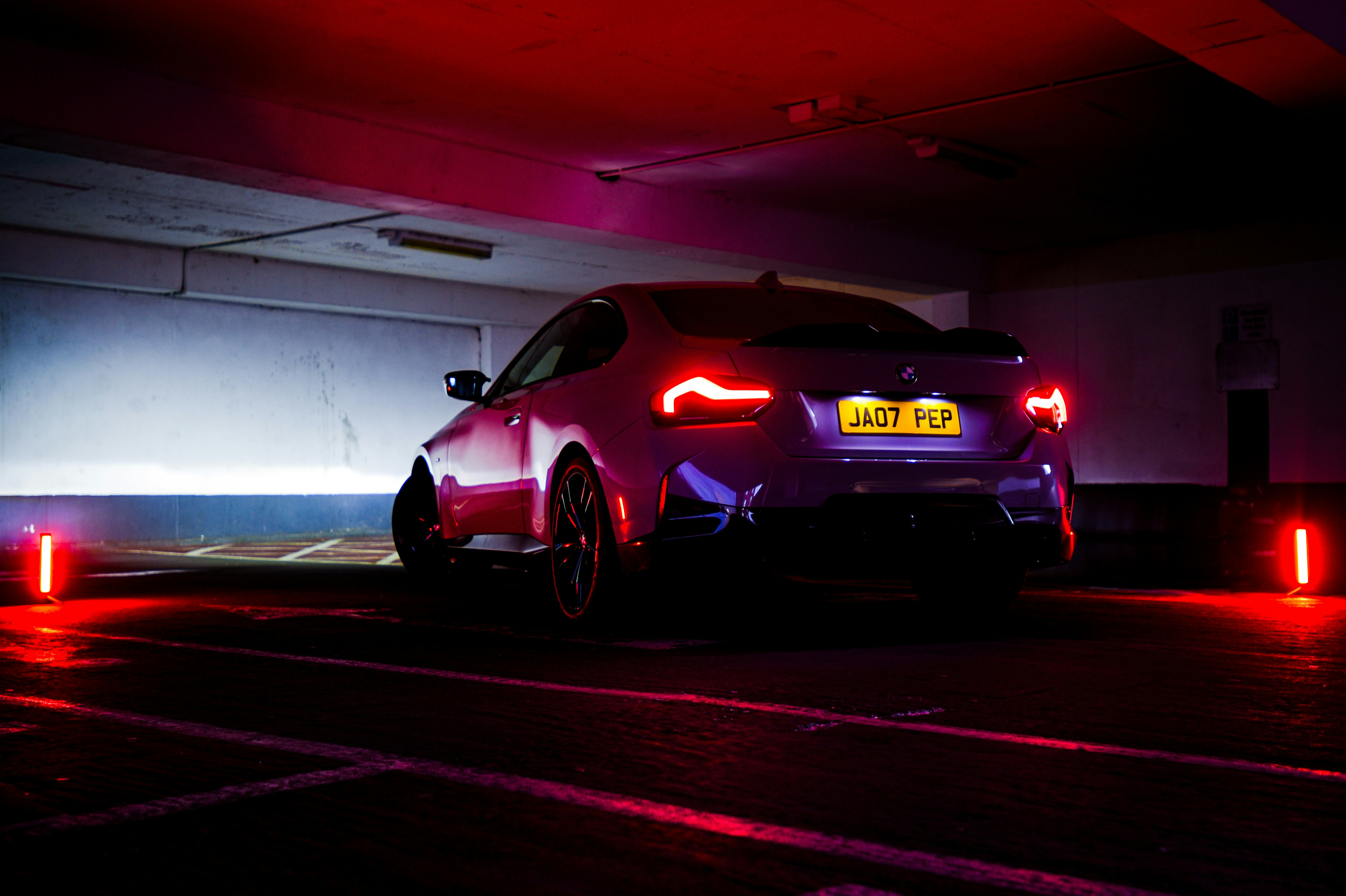 a car parked in a parking garage at night