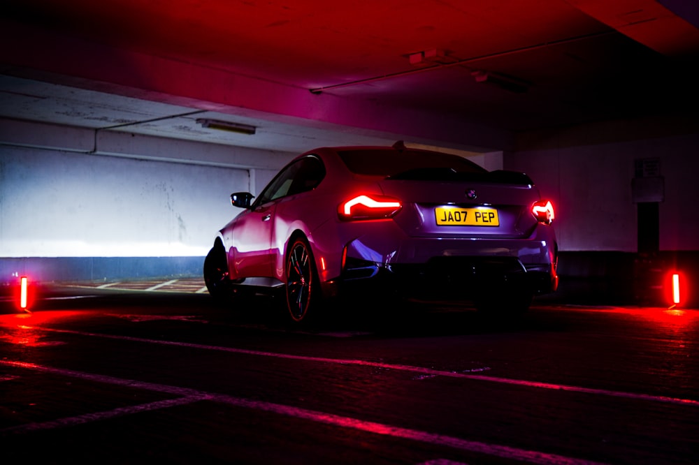 a car parked in a parking garage at night