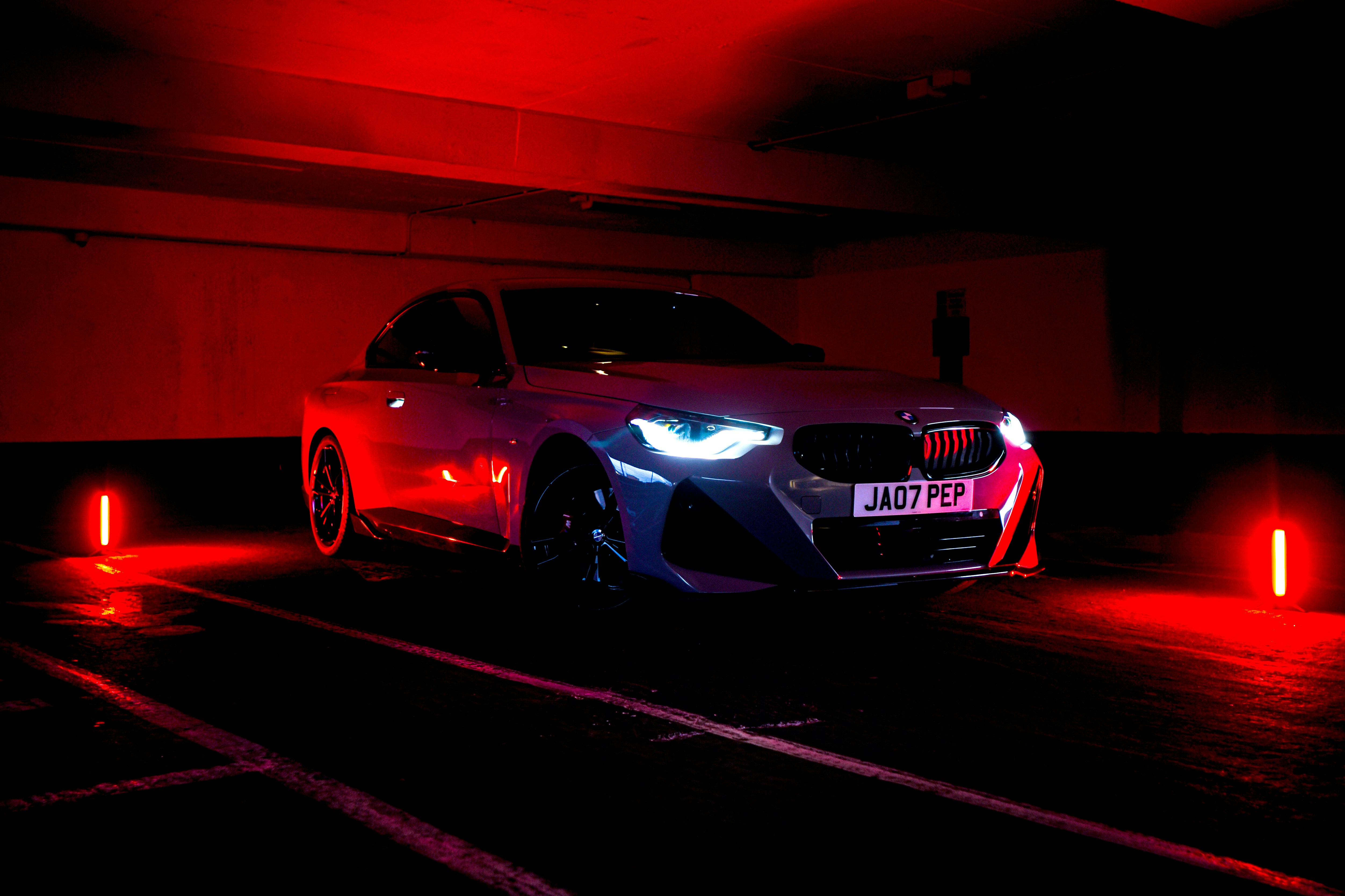 a car parked in a parking garage at night