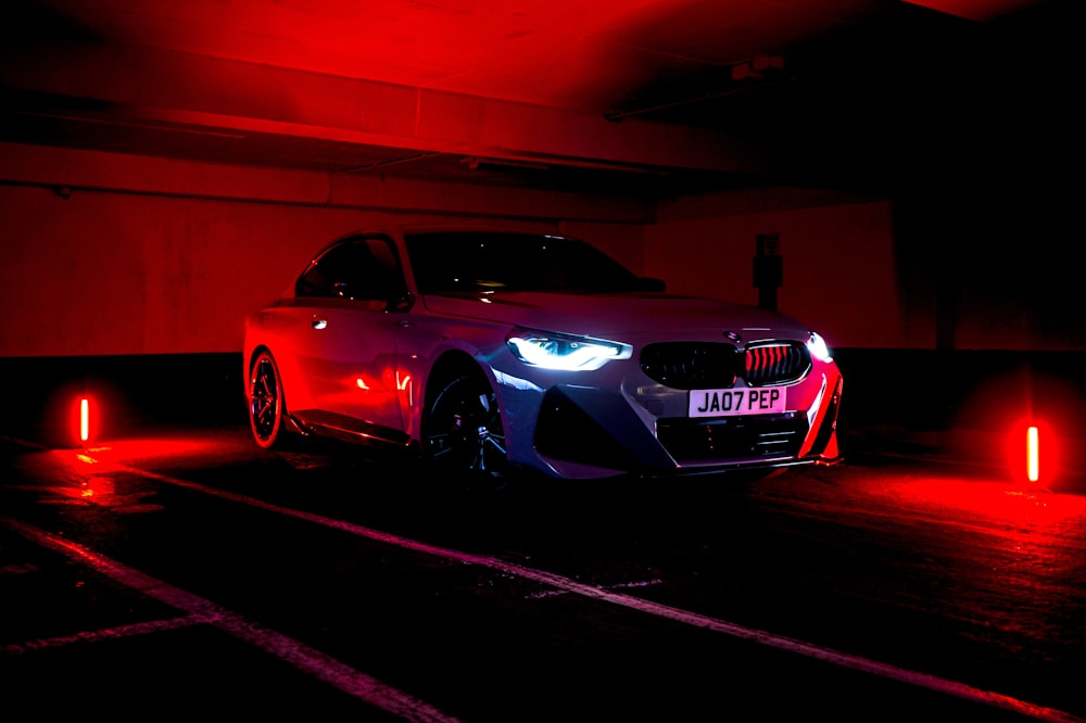 a car parked in a parking garage at night