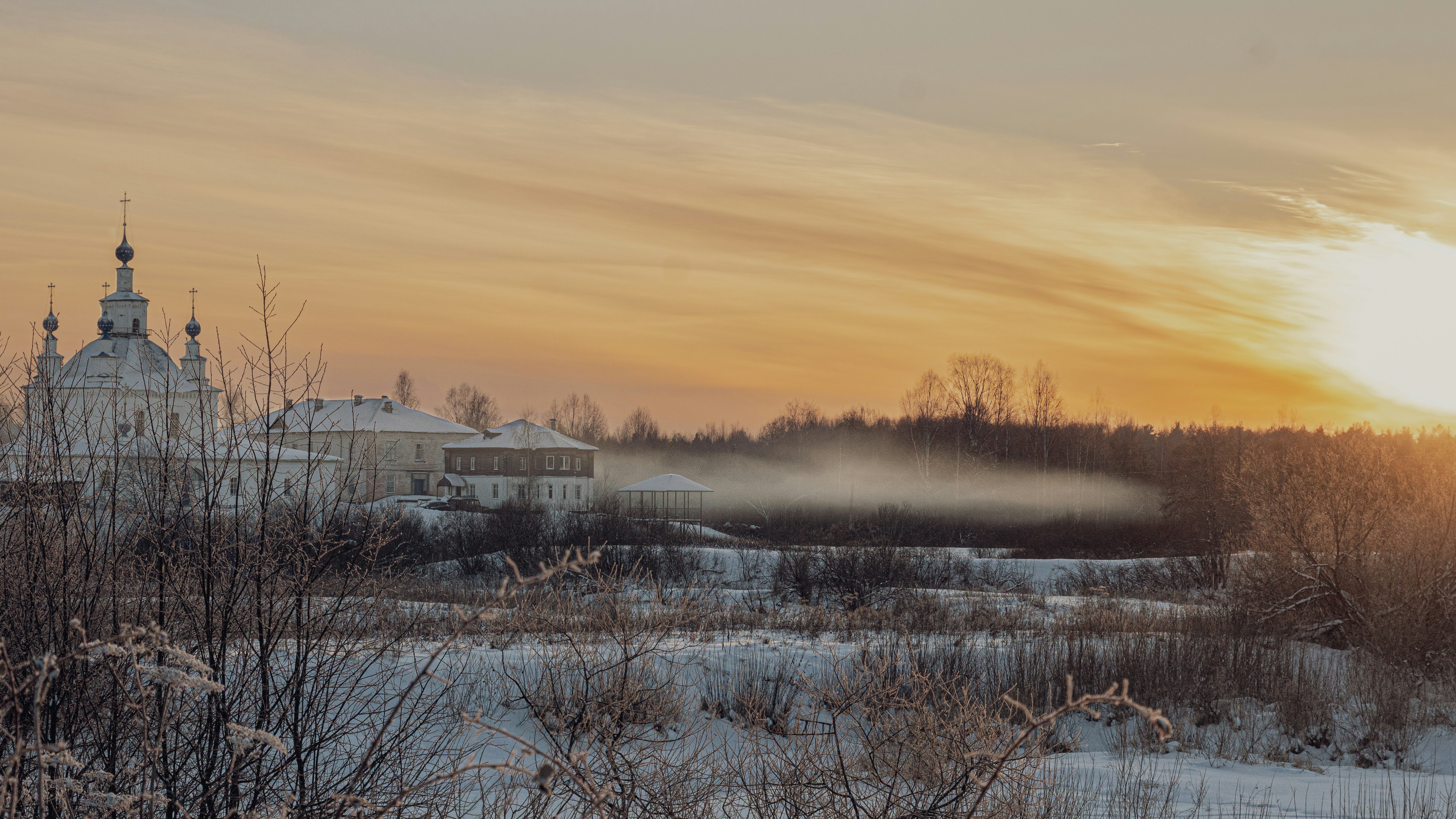 a snowy landscape with a church in the background